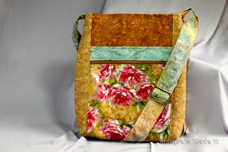 The two zip hipster bag has a front zipped pocket and the top closes with a zip as well. This one is in gold, green and pink to rose colored peony fabric.