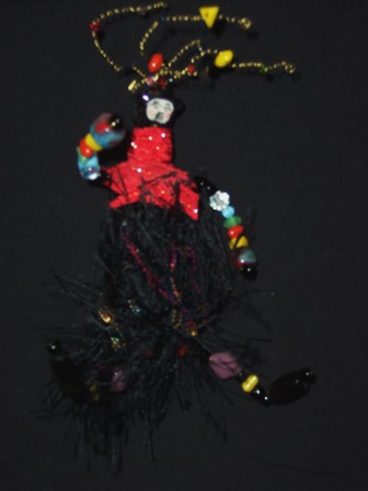 Griselda wearable art brooch in black, multi, and red top. Inspired from Guatemalan colors