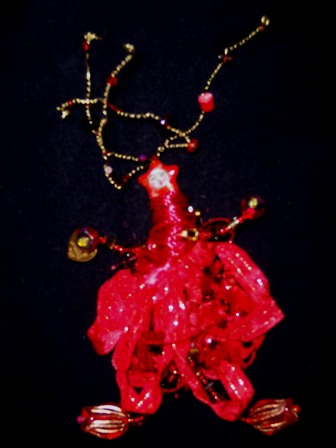 Loving Lizzy wearable art brooch in hot orange red fibers and beads. Loving Lizzy wears her heart in her hand.