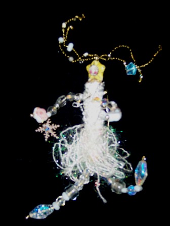 Suzy Snowflake wearable art brooch in white fibers and white and ice blue beads. She comes with her own snow charm.