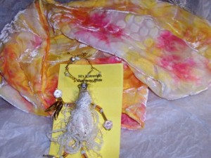 Runaway Bride wearable art pin in whites teamed with a pink, white and yellow scarf